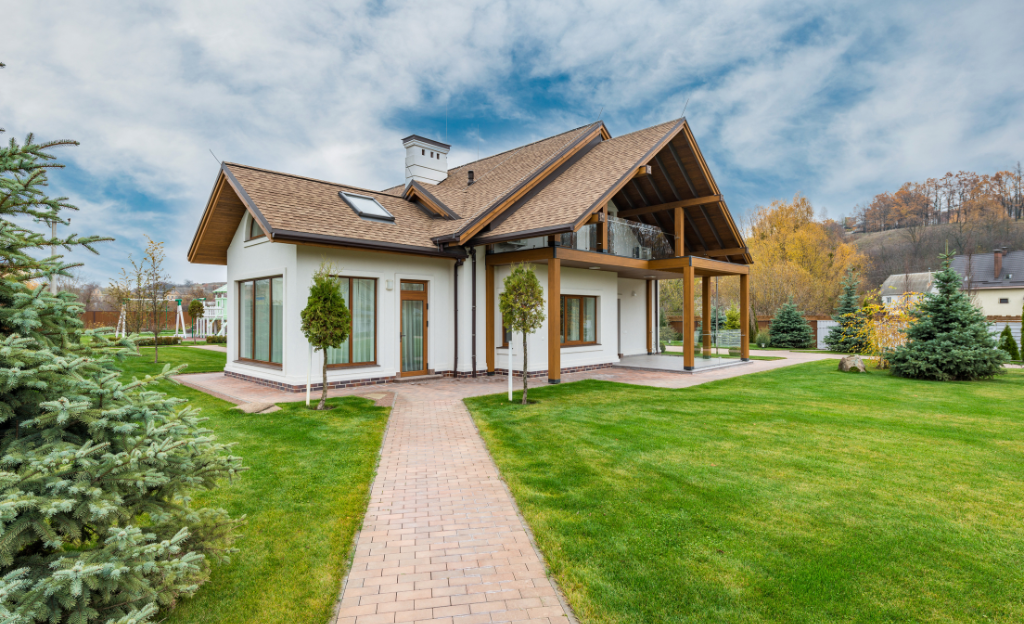 A house with a lawn and a brick walkway

Description automatically generated